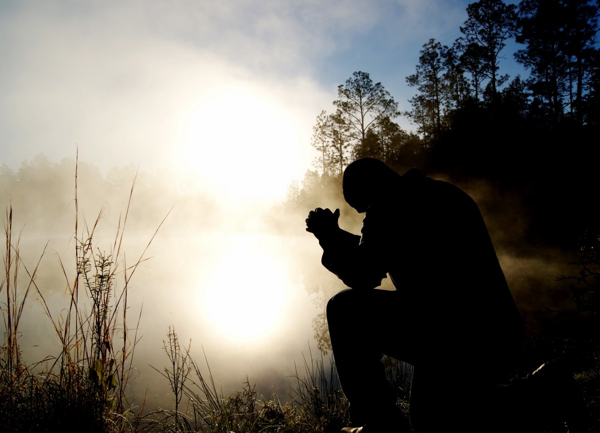 Man praying at dusk